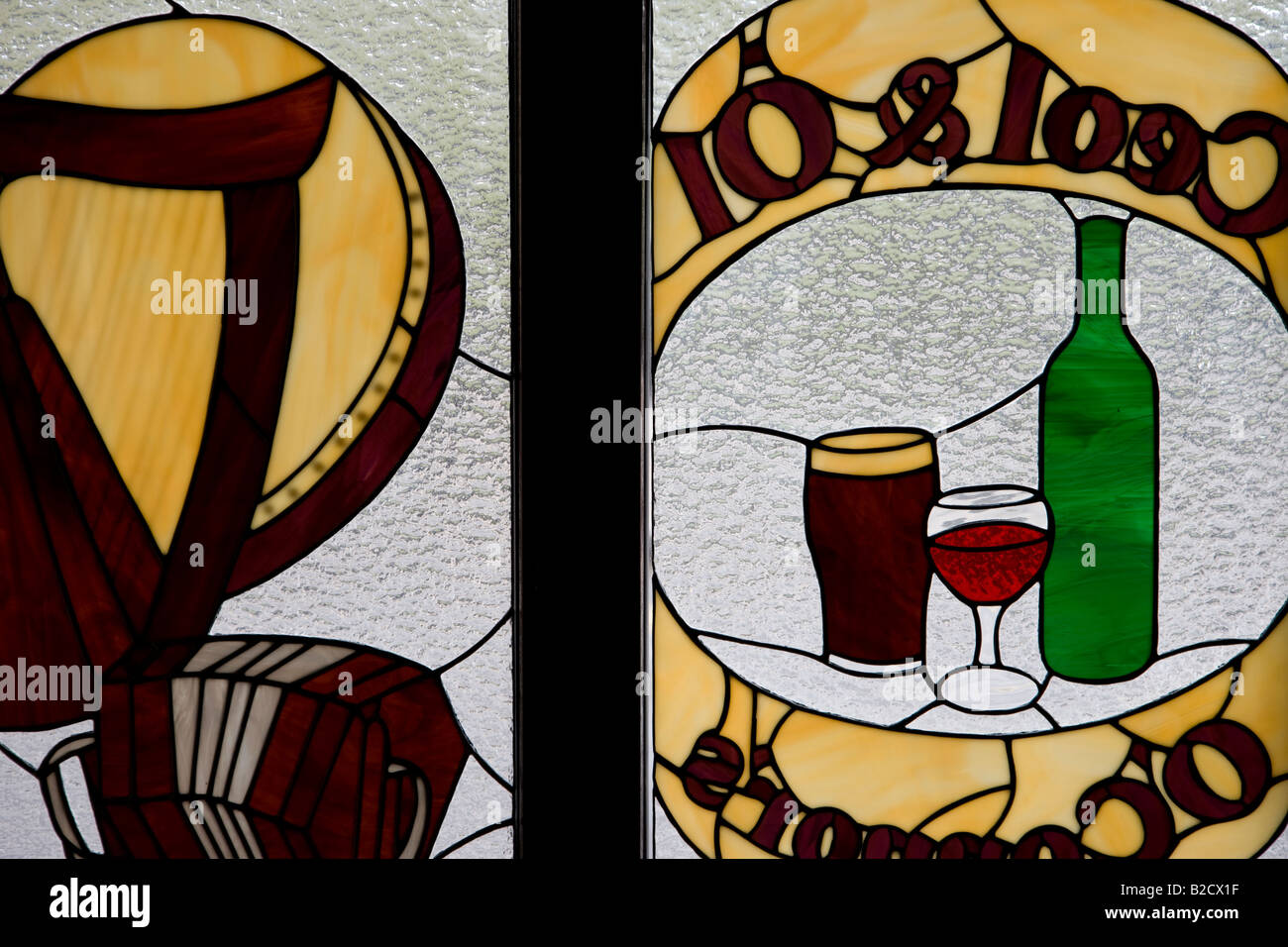 Stained glass signs on Irish pub window, Doolin County Clare, Ireland