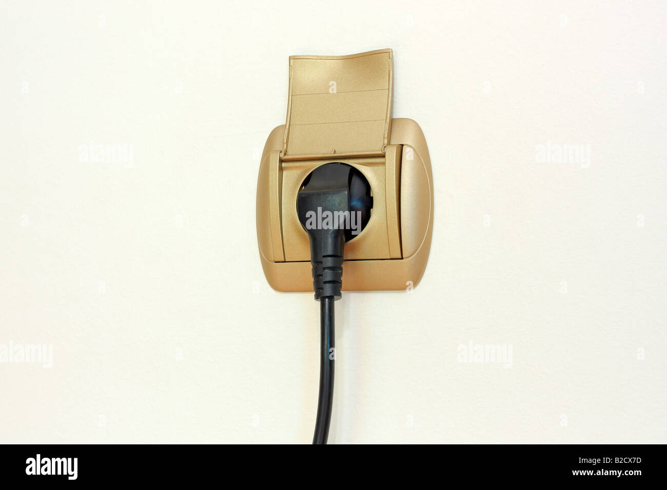 A power cable plugged into a wall socket Stock Photo Alamy