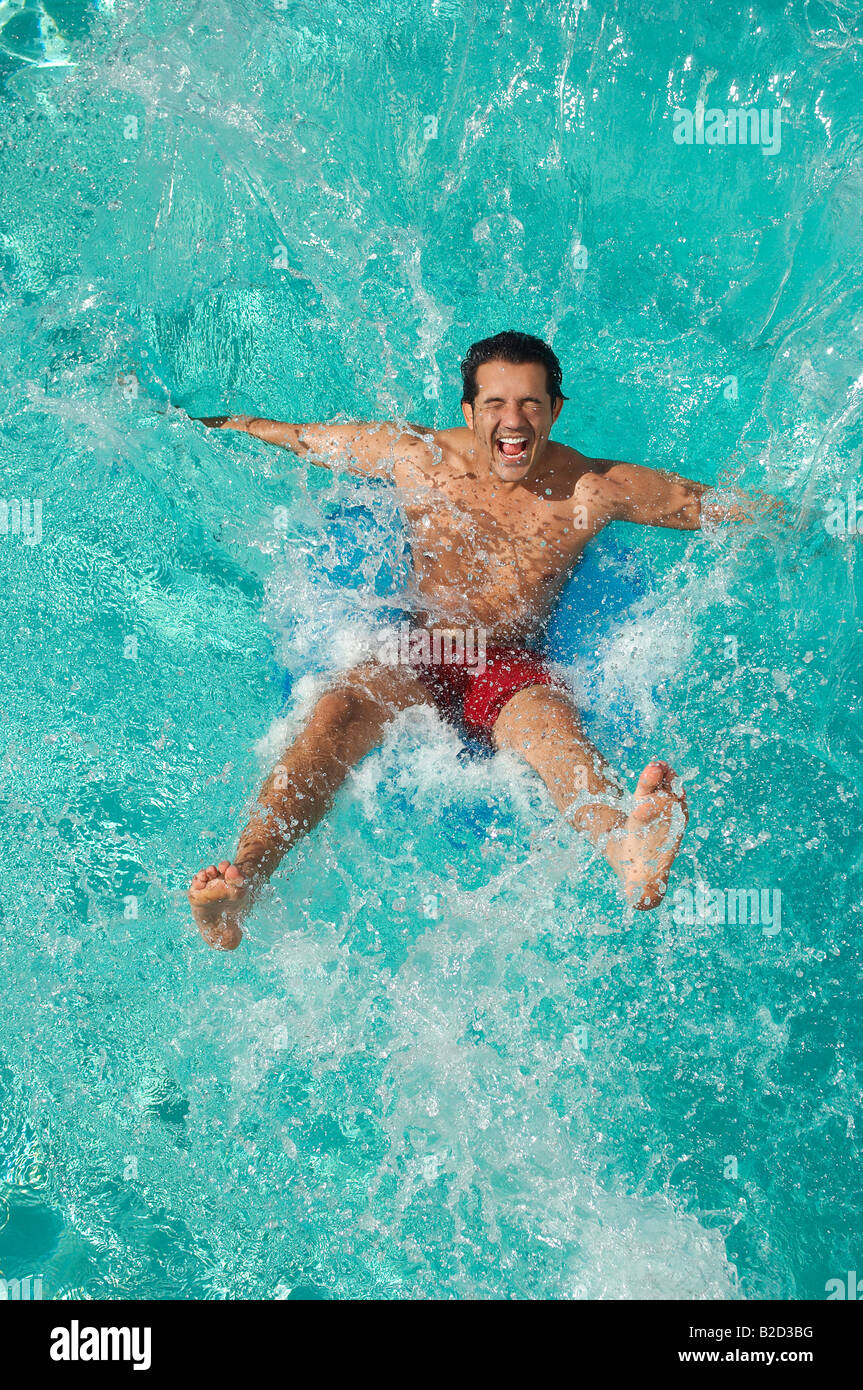 Man falling into swimming pool Stock Photo