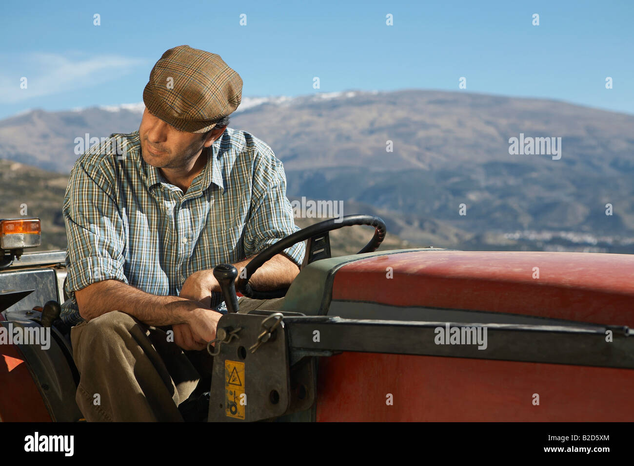 Farmer on tractor Stock Photo - Alamy