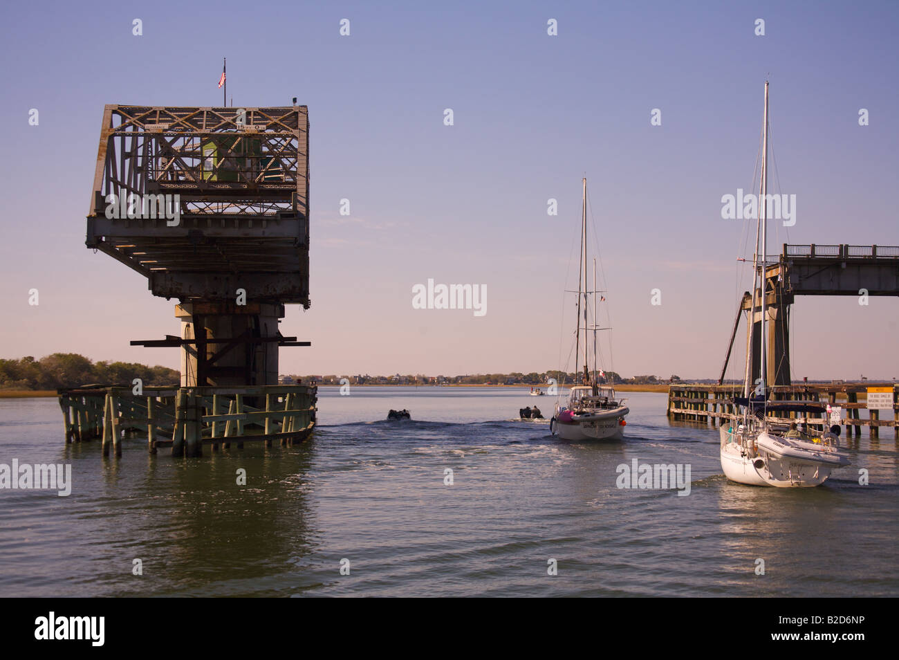 Boats pass under the Sullivan s Island South Carolina swing bridge along the Intercoastal