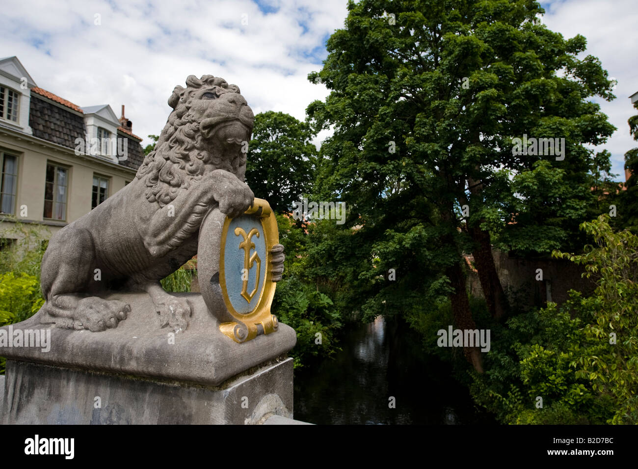 A statue of a lion on the lion bridge or Leeuwenbrug in Bruges holds a shield Stock Photo