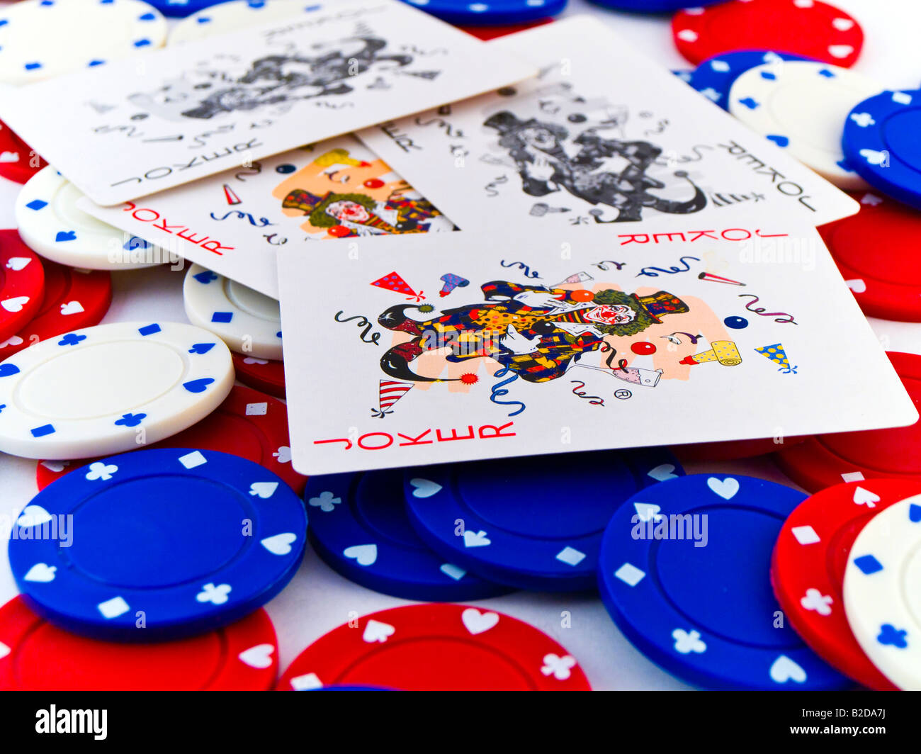 Red White and Blue Poker Chips and Jokers on White Background Stock