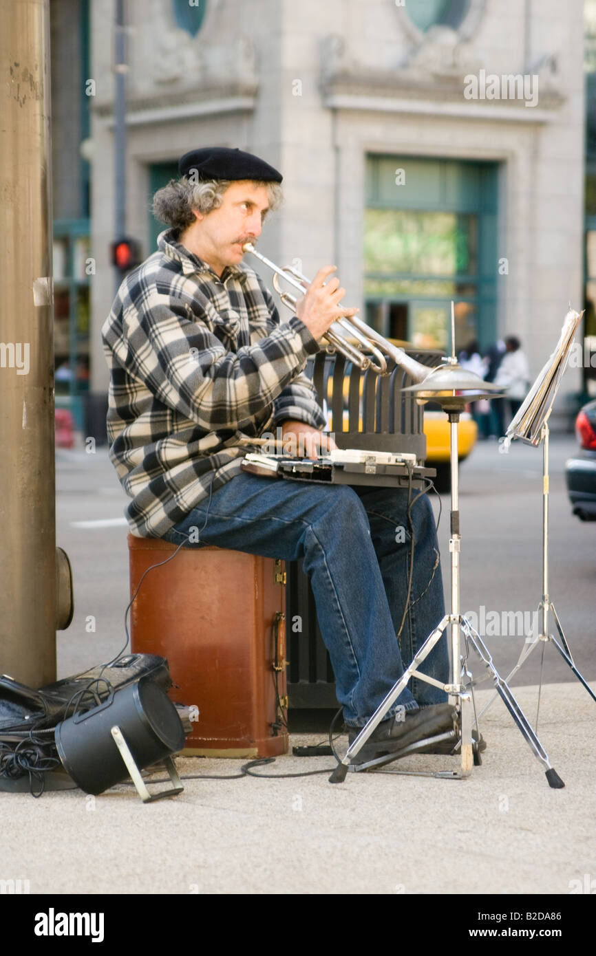 Musical Street performer in Chicago playing the trumpet and keyboard on a summers day. Stock Photo