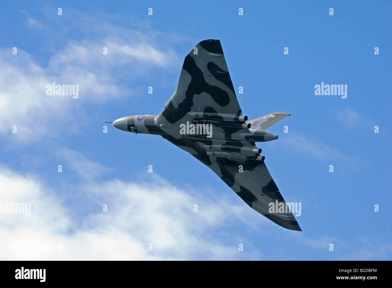 An RAF delta-wing Vulcan bomber in flight, underside view from ground. Stock Photo