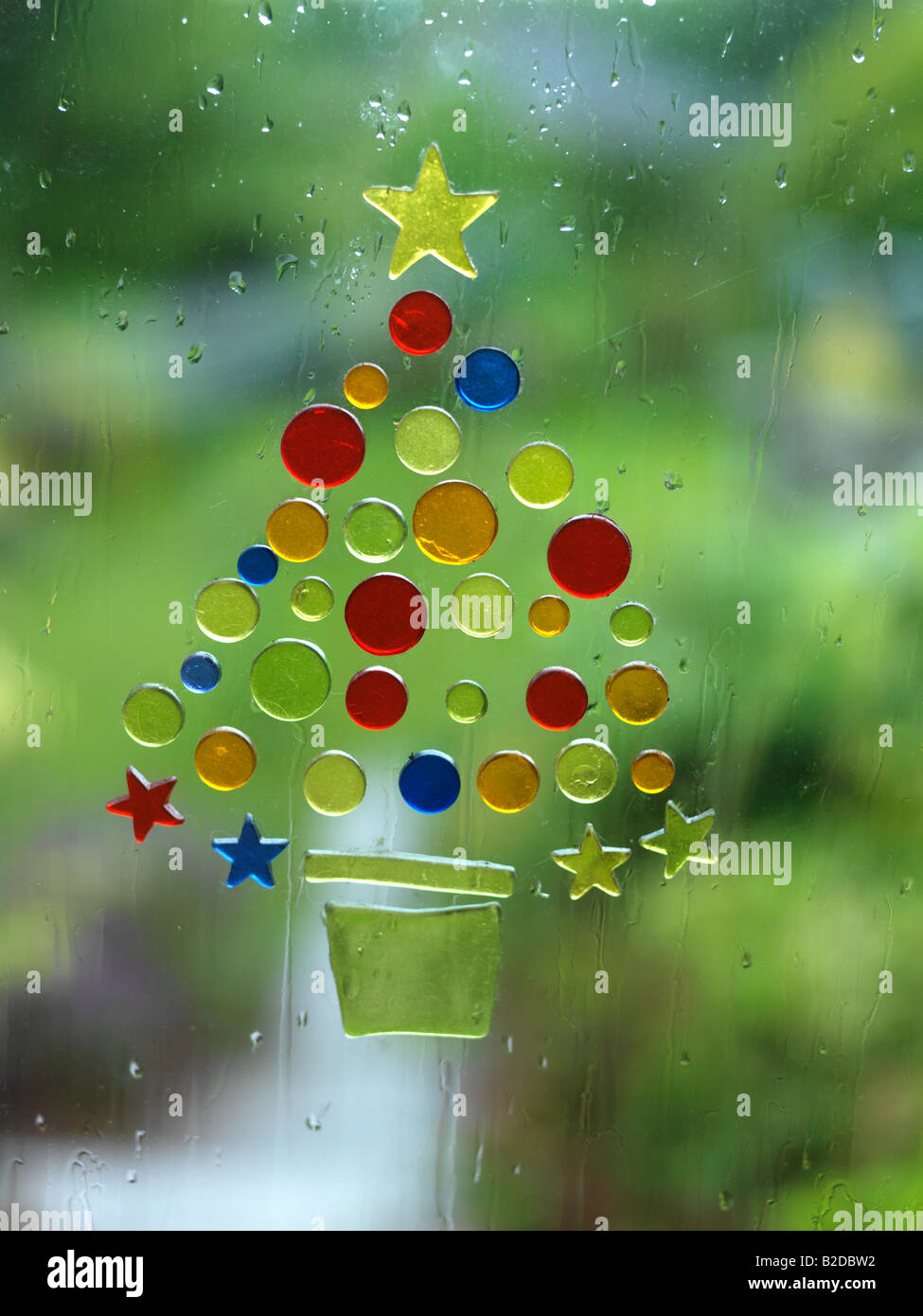 Christmas Tree sticker shapes on rainy window Stock Photo Alamy
