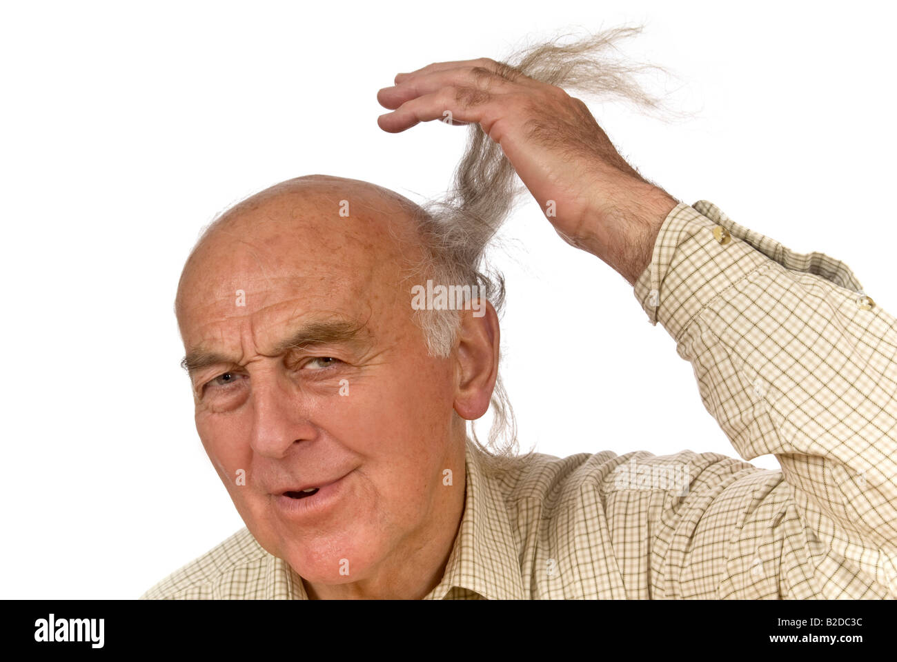 Horizontal close up portrait of an elderly gentleman supporting a lengthy comb over hairstyle Stock Photo