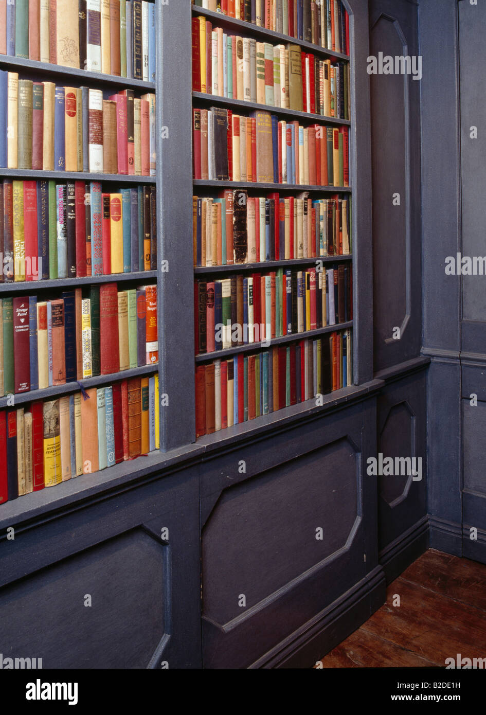 Close up of books on grey bookshelves in library Stock Photo