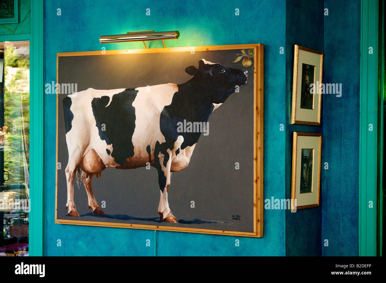 Hotel Saint Christophe in La Baule, the Dining room decor with large painting of a cow Stock Photo