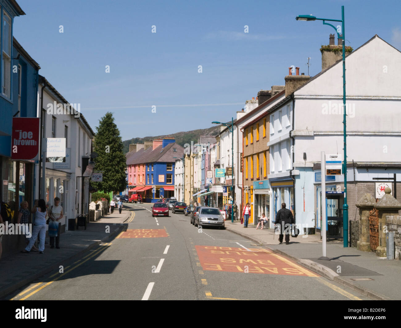 View along village main high street with colourful buildings. Llanberis Gwynedd North Wales UK Britain Stock Photo