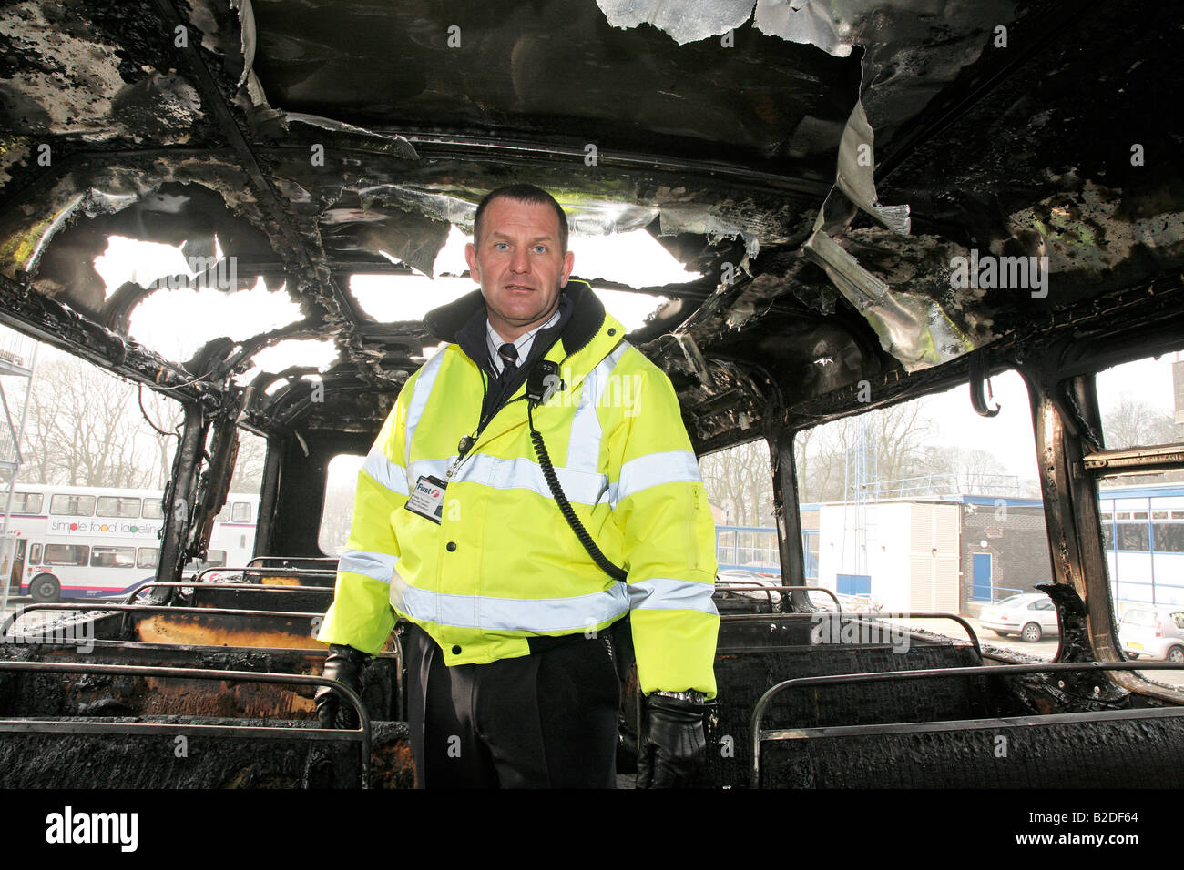 Official surveying fire damaged bus Stock Photo