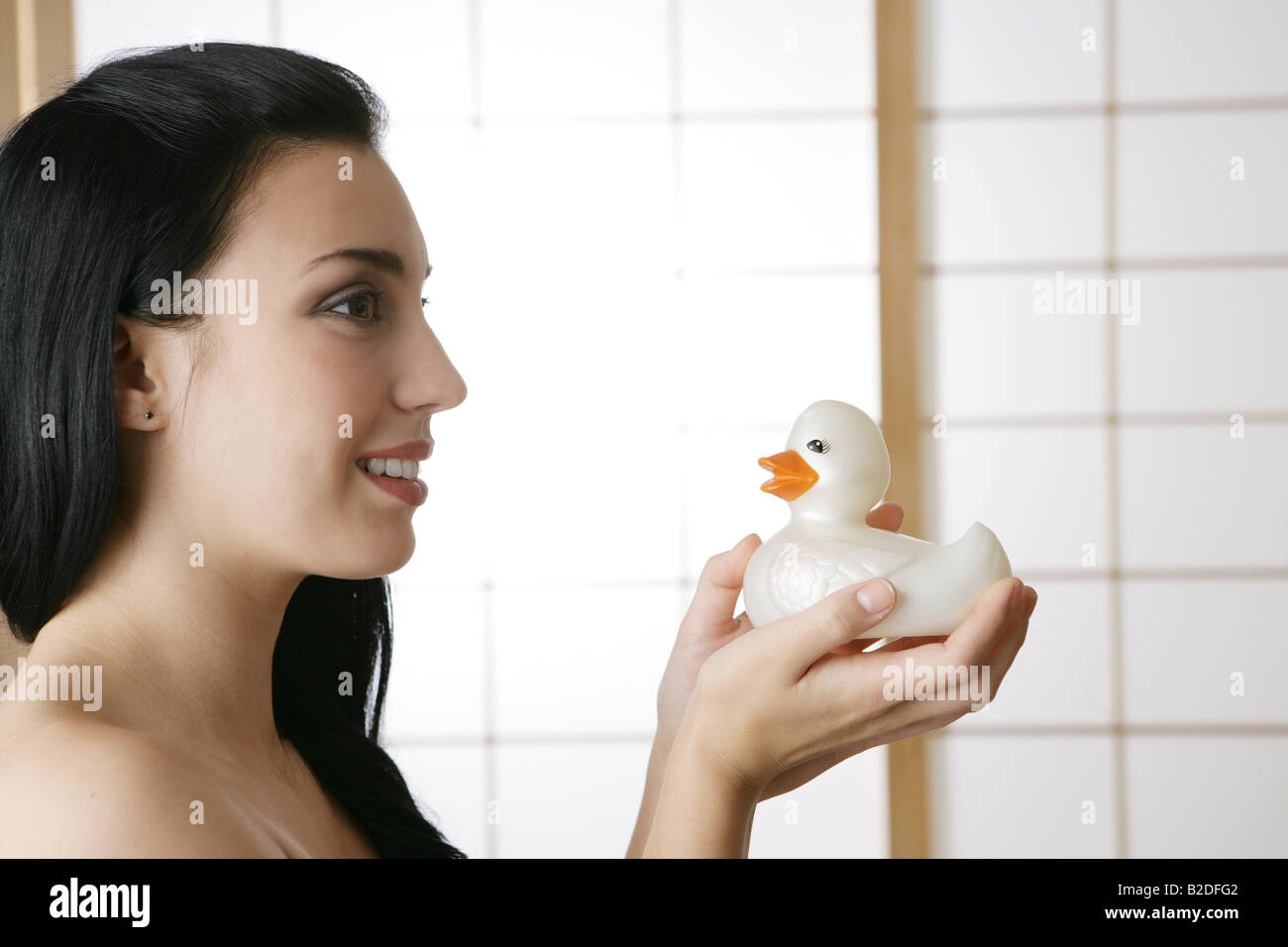 Young woman holding rubber duck. Stock Photo