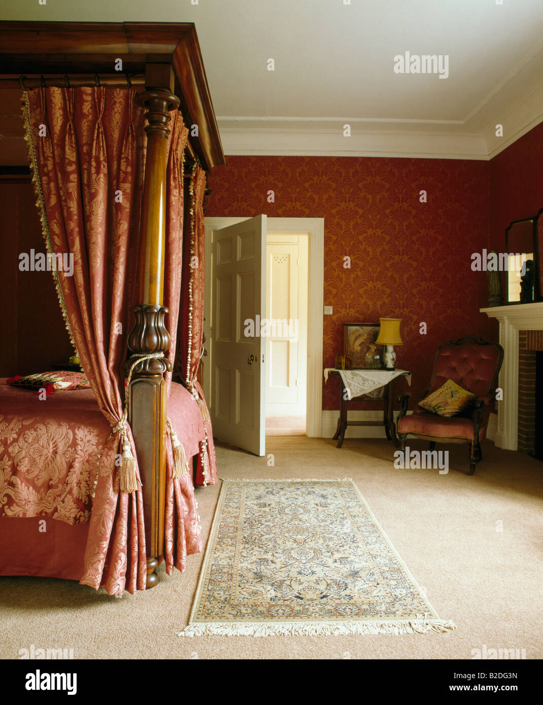 Red Damask Drapes On Antique Fourposter Bed In Red Bedroom