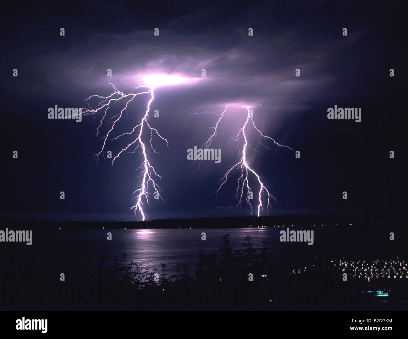 Couple Electric Lightning Strike over Elliott Bay Bainbridge Island Seattle Washington Stock Photo