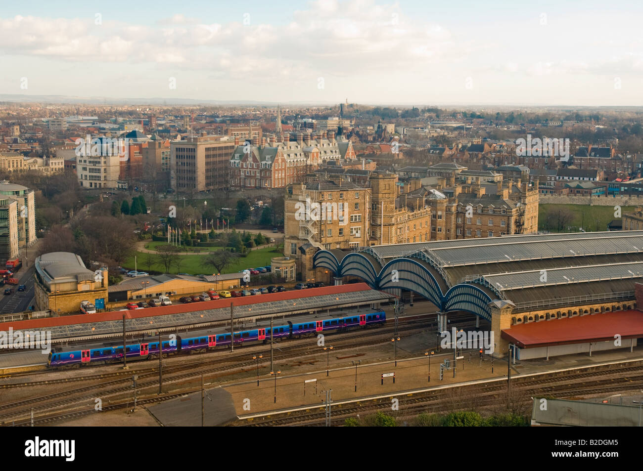 Elevated view of the York city with the platforms of York station with their curved roofs in the foreground. York. UK Stock Photo