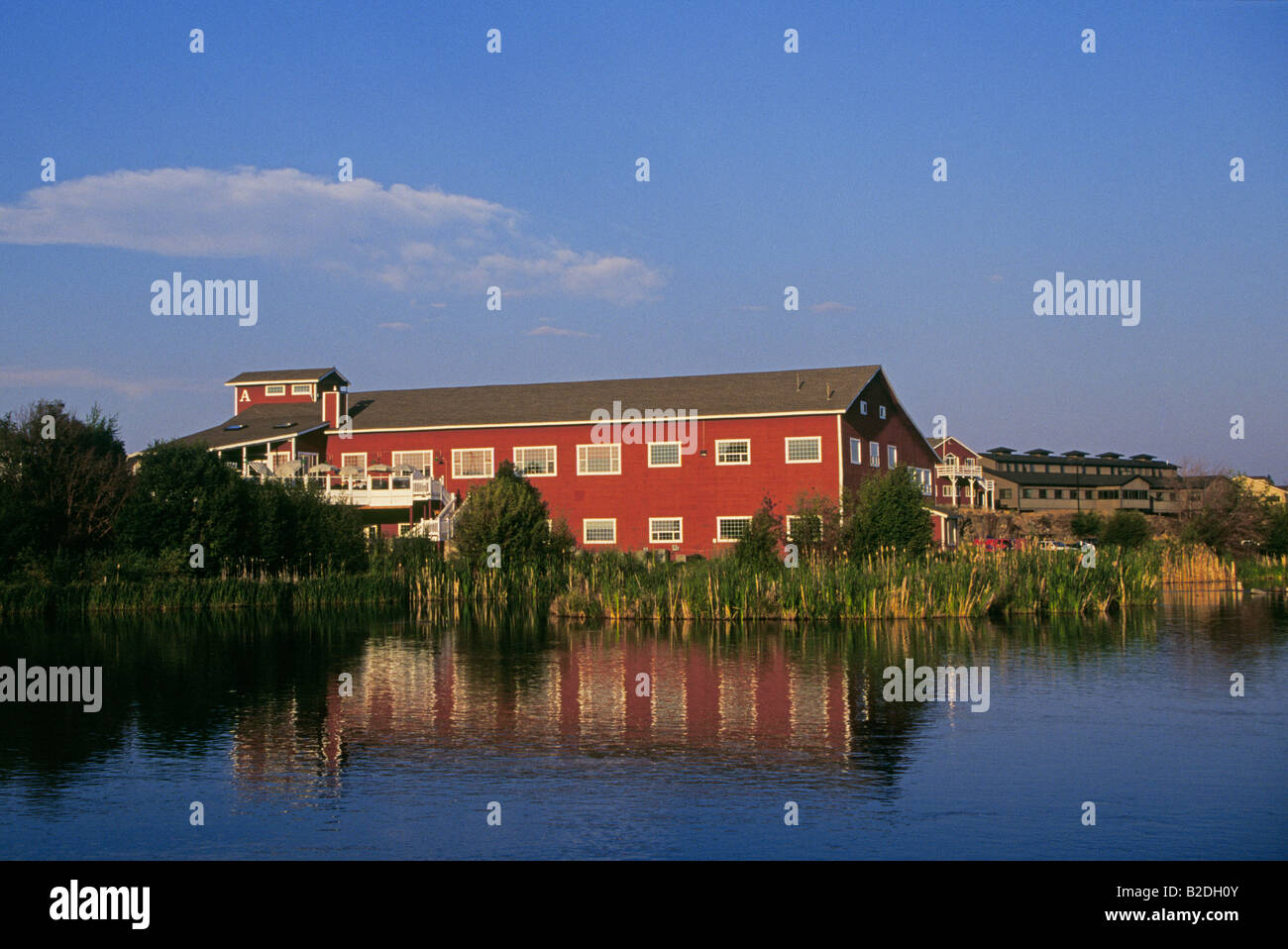 A view some of the old red buildings in the Old Mill District along the  Deschutes River in the peak of autumn in Bend Oregon Stock Photo - Alamy