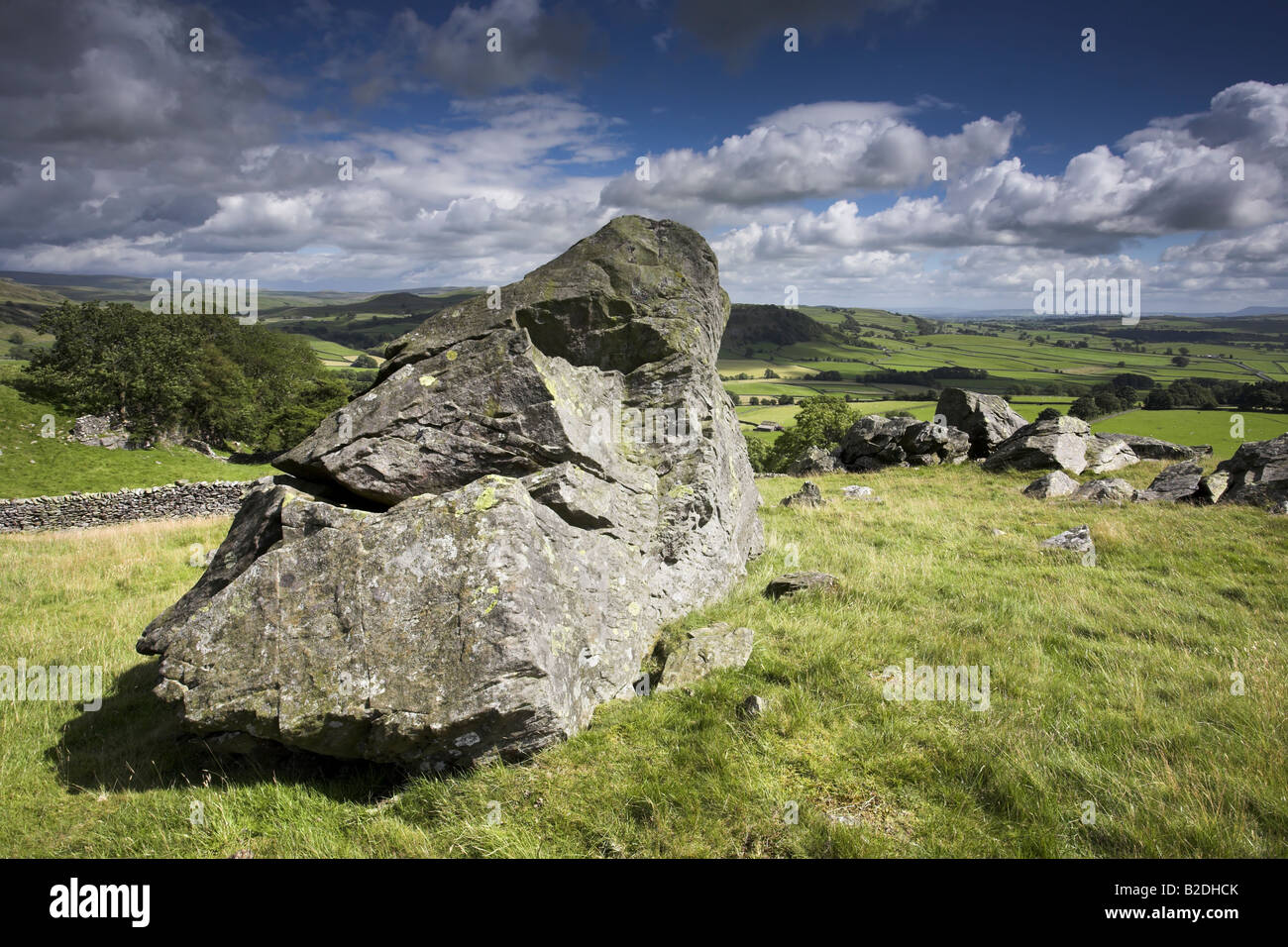 Glacial Erratic on Norber Brow with a view over Crummackdale Austwick Yorkshire Dales UK Stock Photo