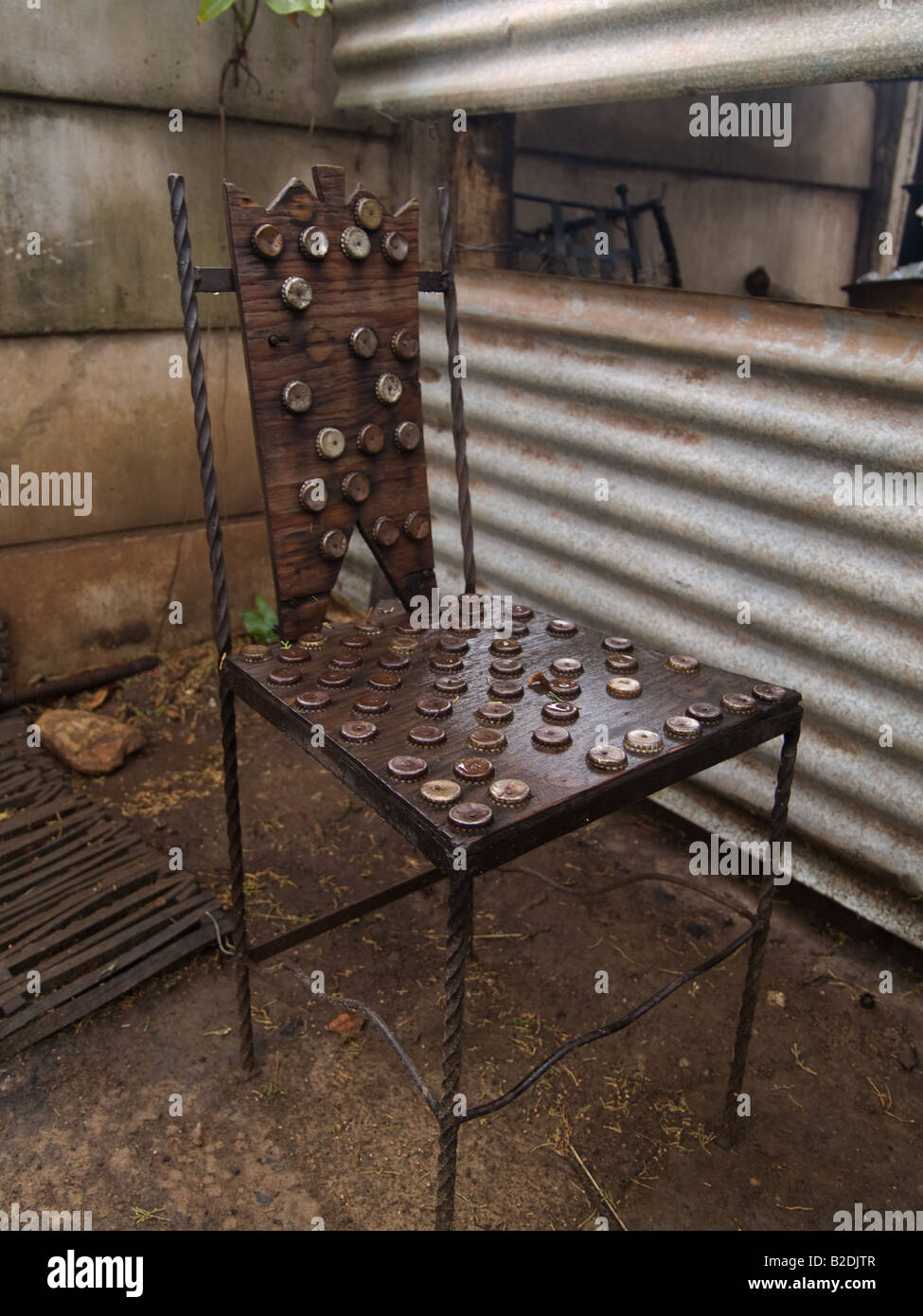 A chair made from found objects, including plywood and bottletops