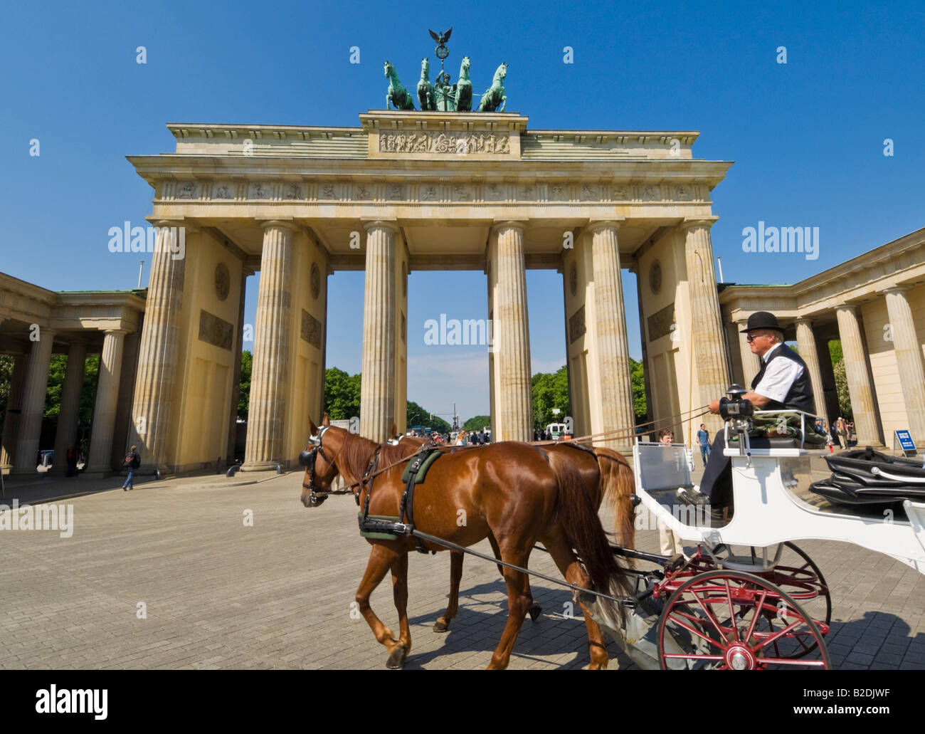 Brandenburg gate Pariser Platz with the winged Quadriga statue tourist horse and carriage ride Berlin city centre Germany eu Stock Photo