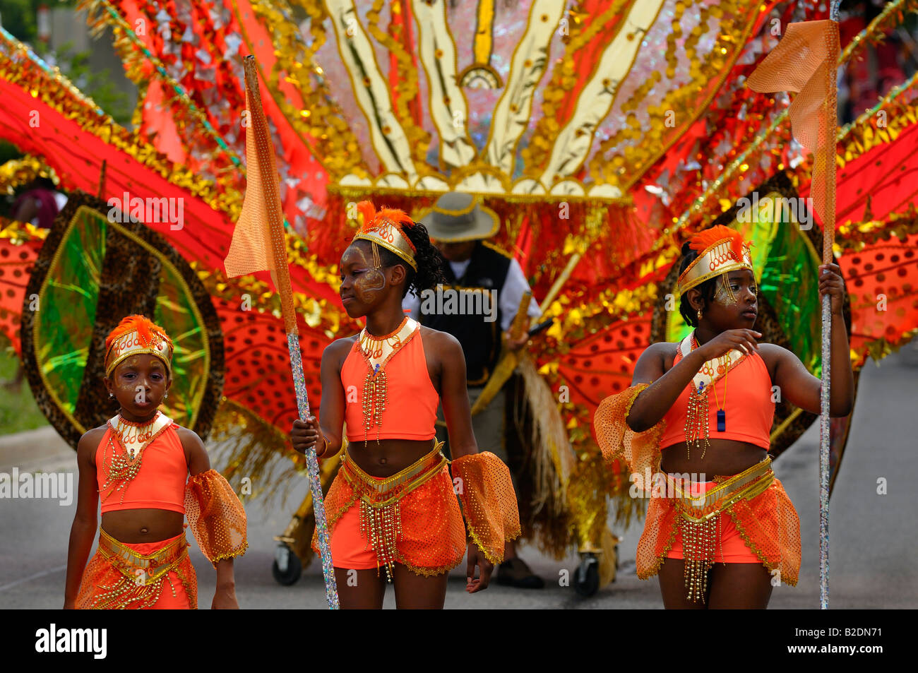 Three young reveler Masquerader dancers in orange at the Junior Caribana Parade in Toronto 2008 Stock Photo