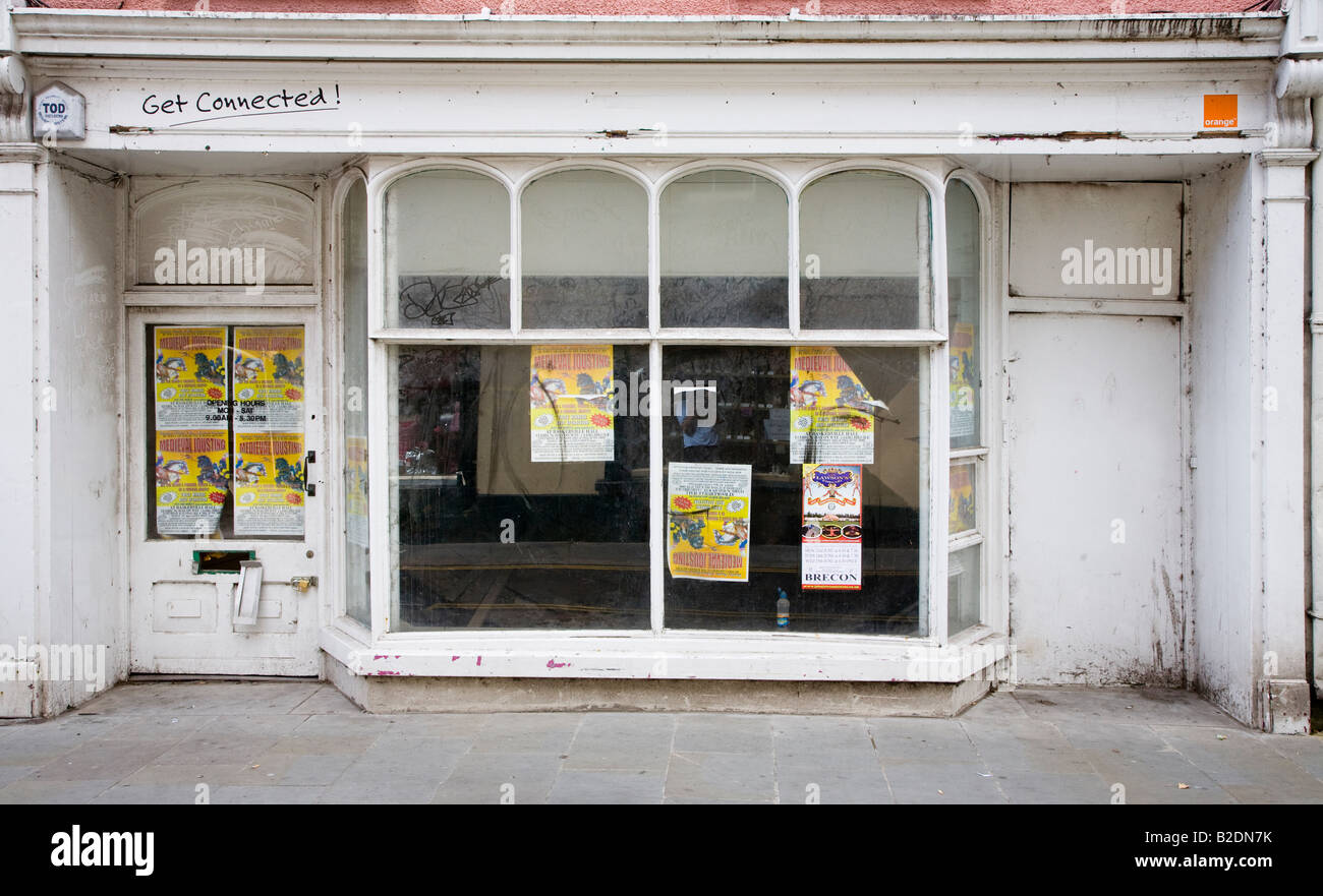 Closed shop with posters in window Brecon town centre Wales UK Stock Photo