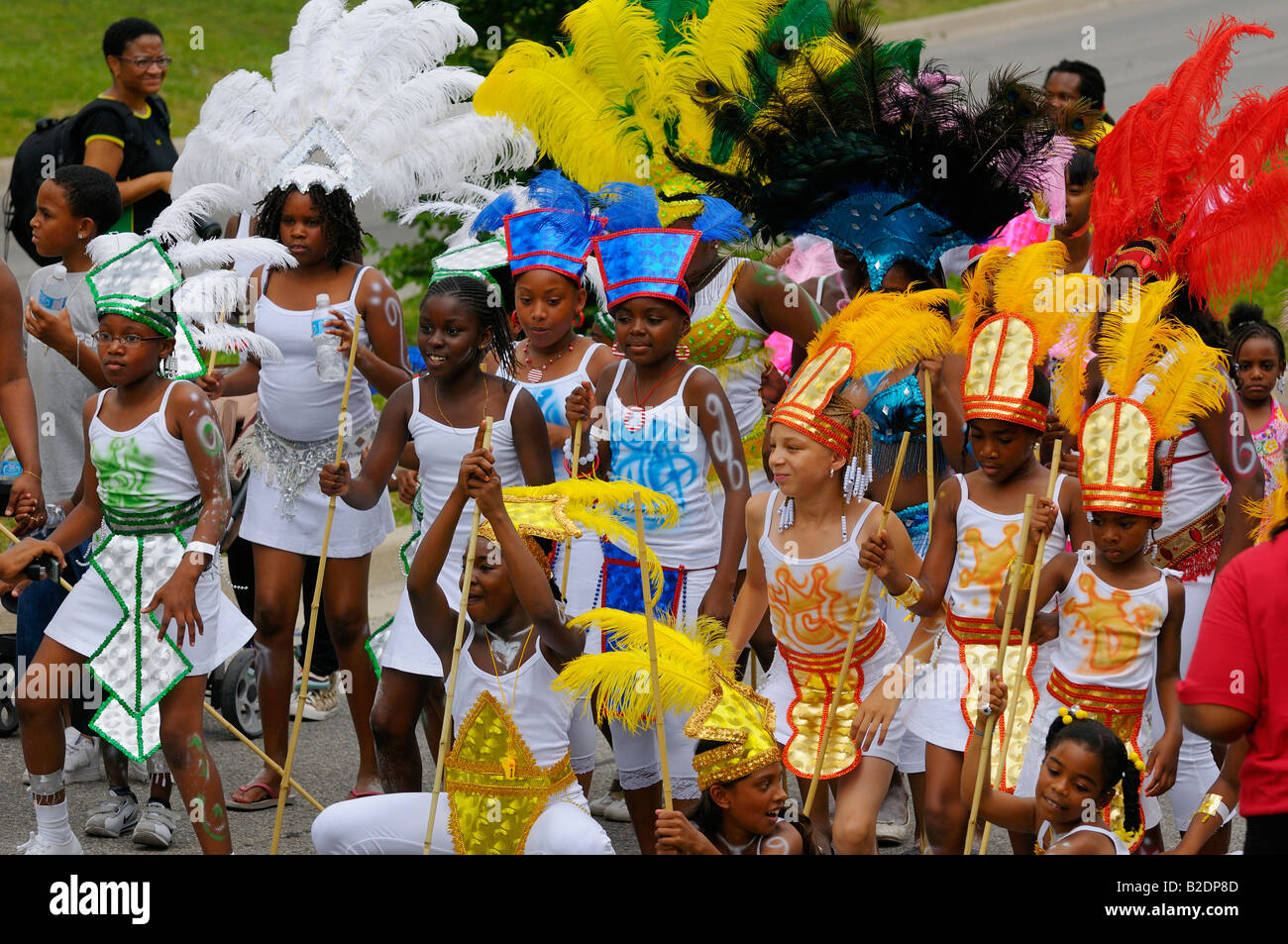 Group of black girls in white costumes jumping up at the Junior Caribana carnival Parade Toronto 2008 Stock Photo