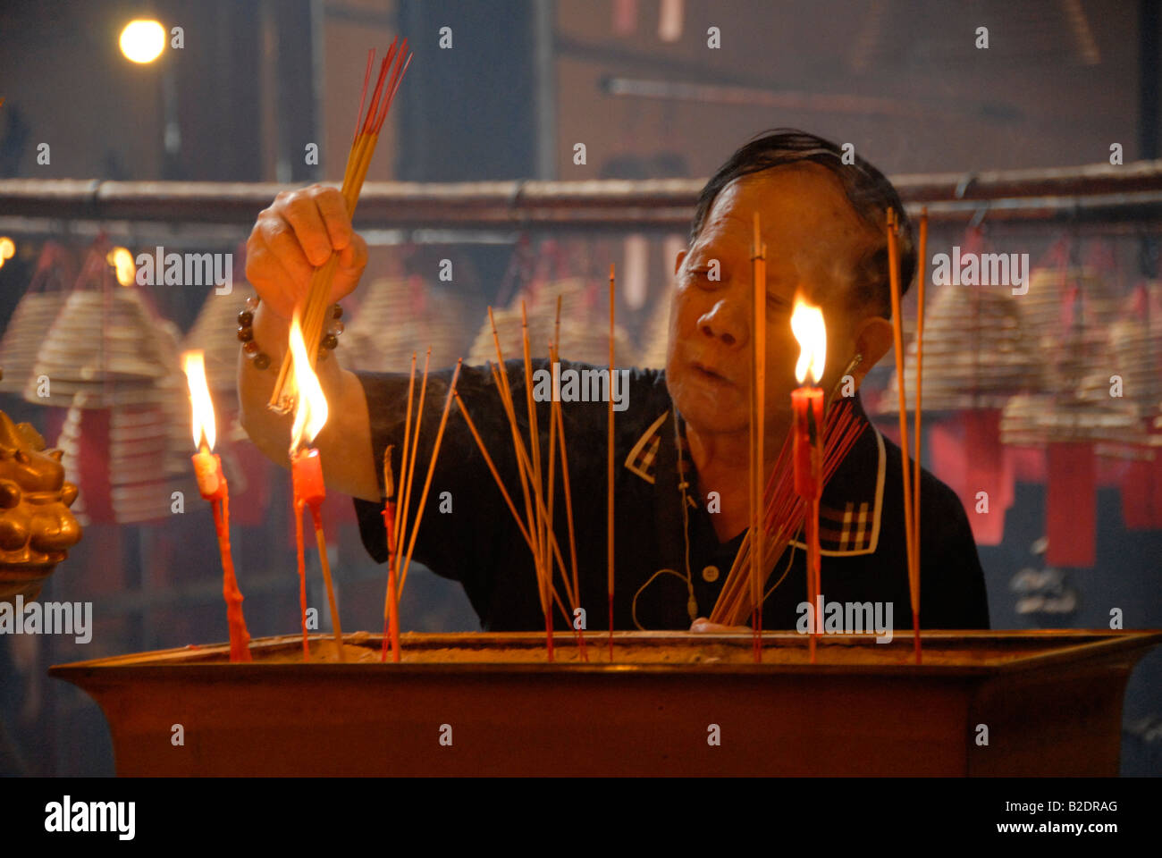 man opening candle,Man Mo Temple, Hollywood Road, Hong Kong, China