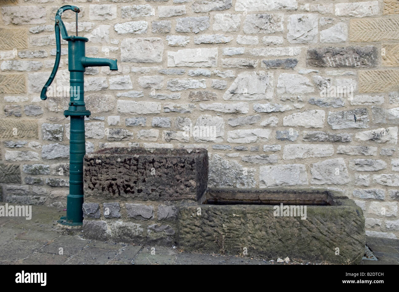 Hand pull water pump and stone troughs in Great Longstone  Derbyshire Great Britain Stock Photo