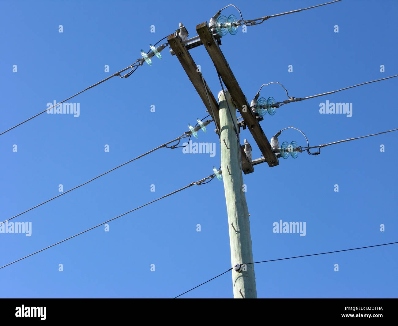 Electric pole and wires against blue sky Stock Photo - Alamy