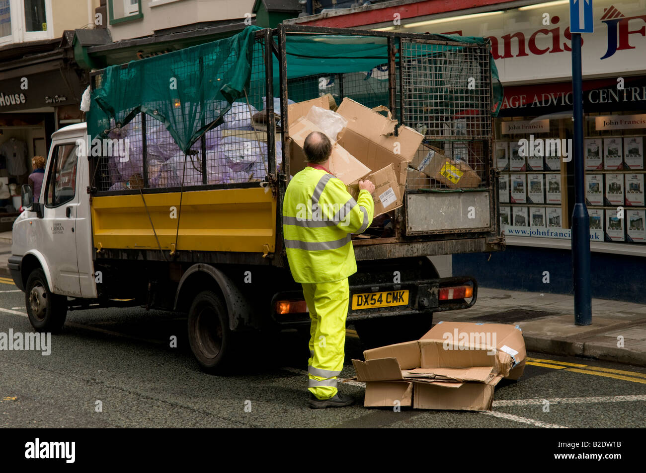 A Local authority worker collecting waste cardboard for recycling from