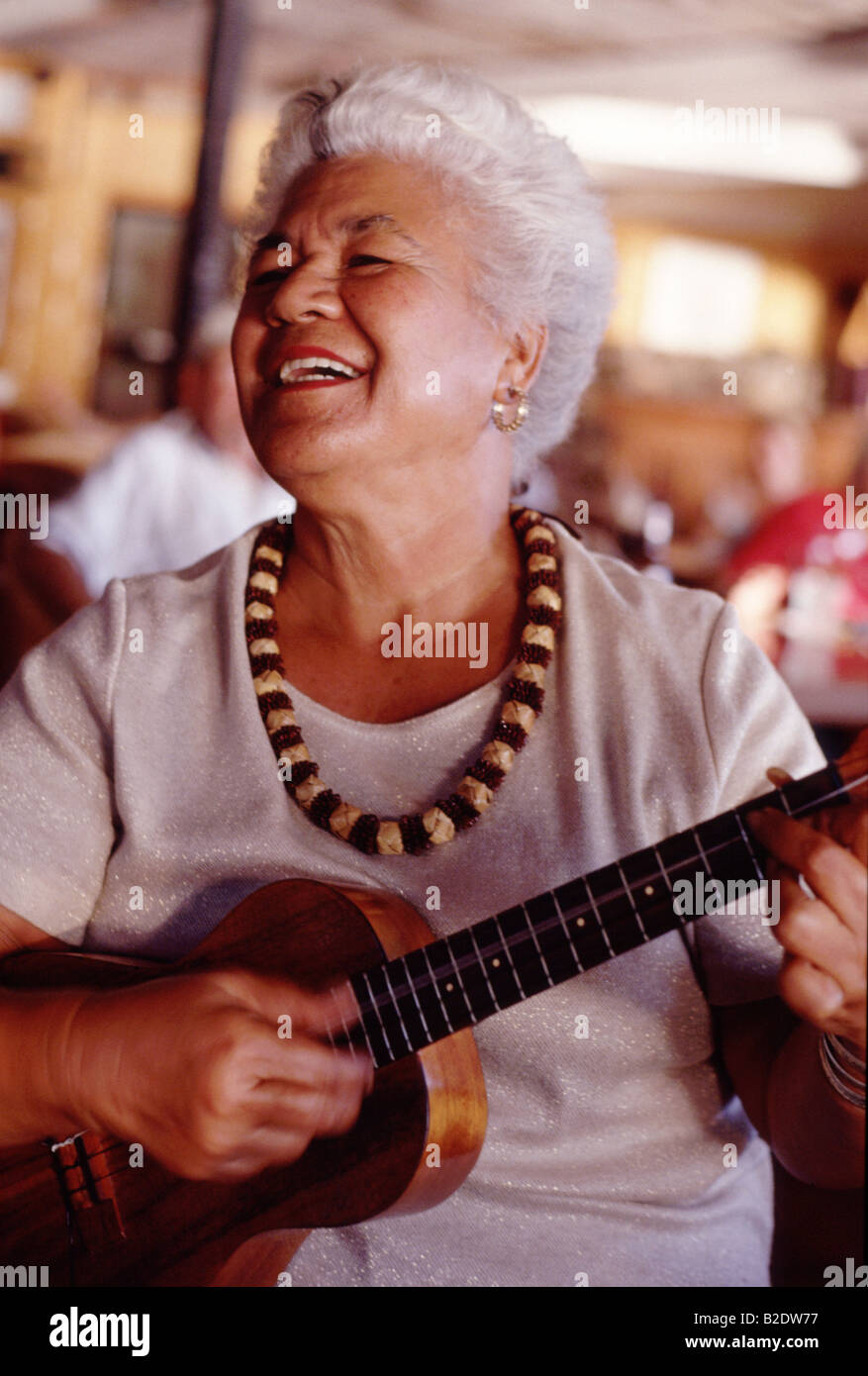 USA Hawaii Molokai, Hawaiian woman plays the ukulele at Hotel Molokai