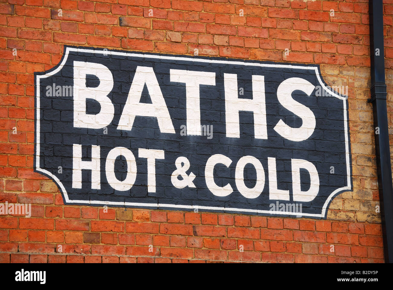 Old baths advertising sign on building, Banbury, Oxfordshire, England