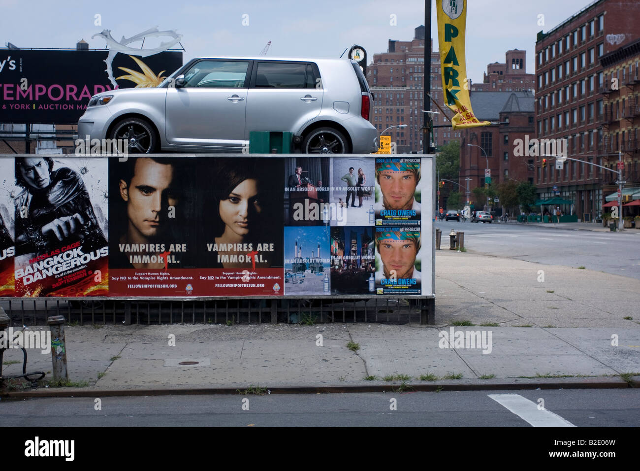 A car in a parking lot and billboards in Chelsea, Manhattan, NYC Stock
