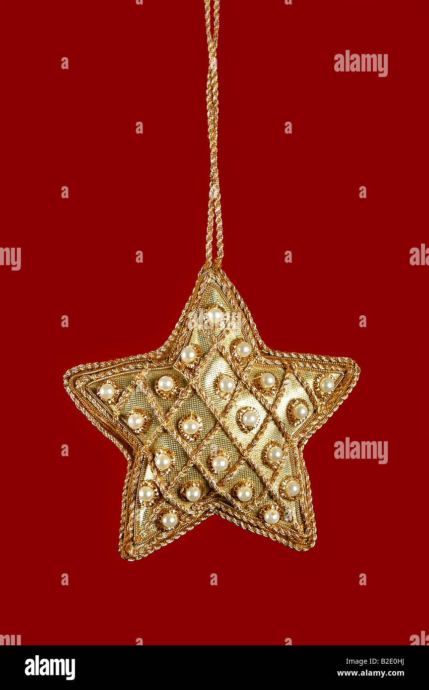 Christmas Star With Pearls and Gold on a red background Stock Photo