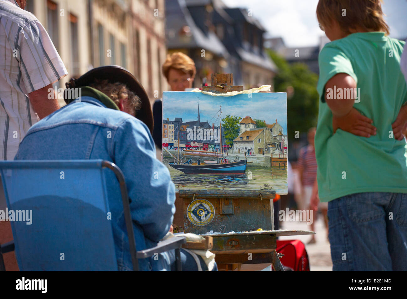 Painter working on painting of the Old Harbour at Honfleur Normandy France Stock Photo