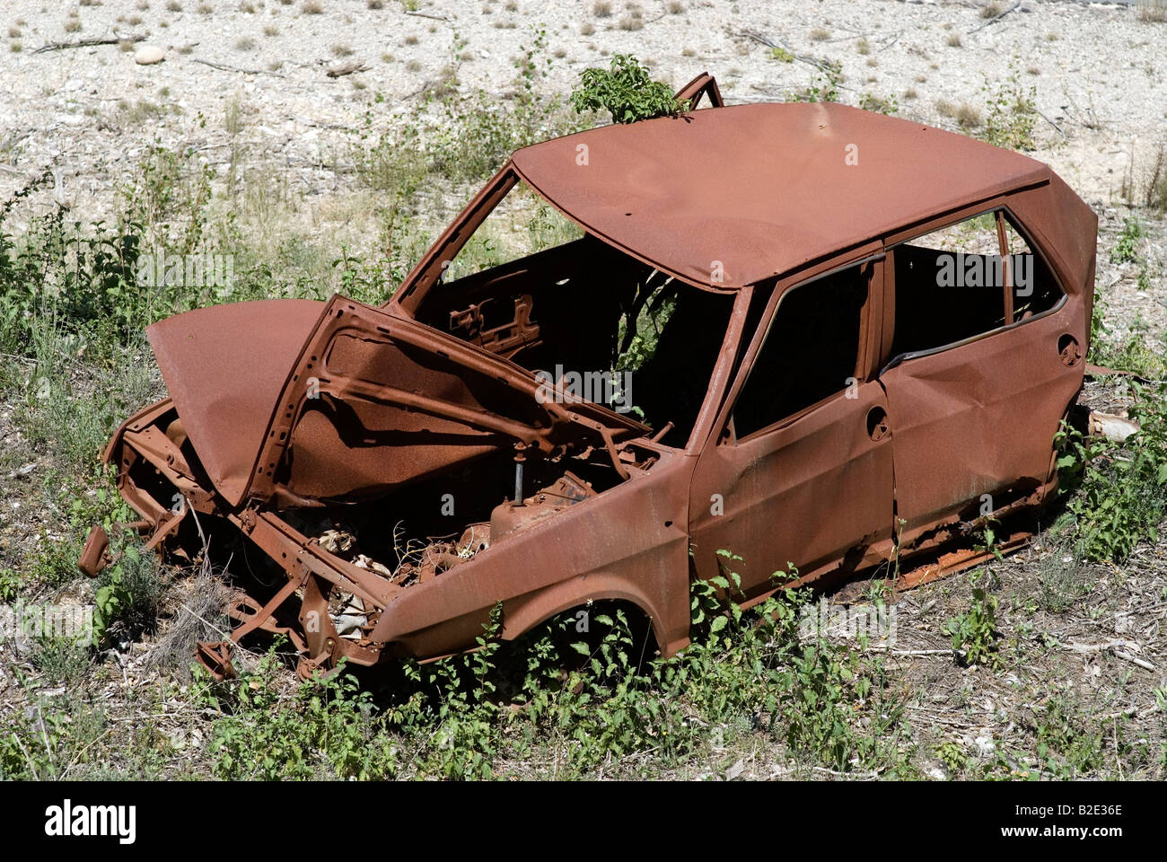 France Vaucluse terminally rusty rusted rusts car small russet rust brown rust brown junk at roadside Stock Photo