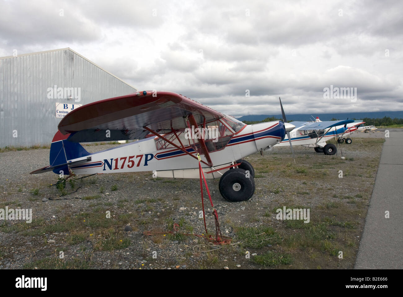 Smal airplane tied to the ground at airstrip in Alaska. Stock Photo