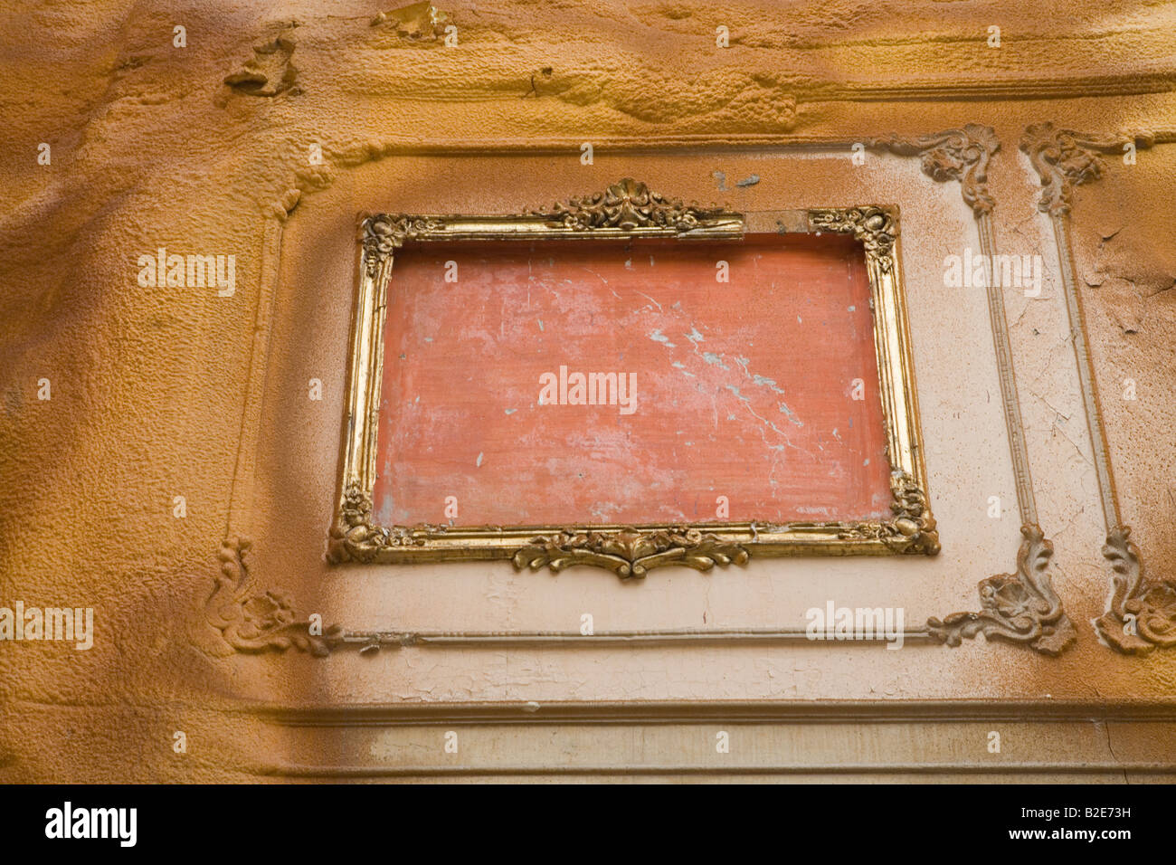 Gilt frame in embedded in old brick wall Stock Photo