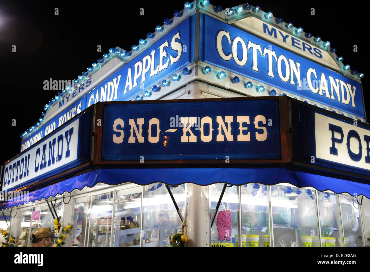 Cotton candy shop lit up at fairground hires stock photography and