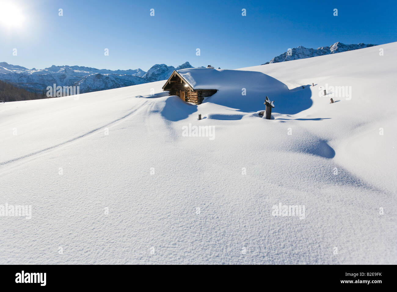 Log cabin covered with snow on polar landscape, Berchtesgaden Alps, Bavaria, Germany Stock Photo