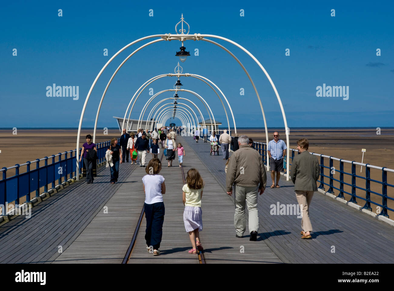 People walking on jetty Southport Lancashire England Stock Photo