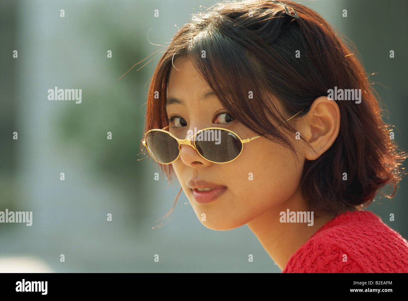 A portrait of a young Asian woman wearing sunglasses Stock Photo - Alamy