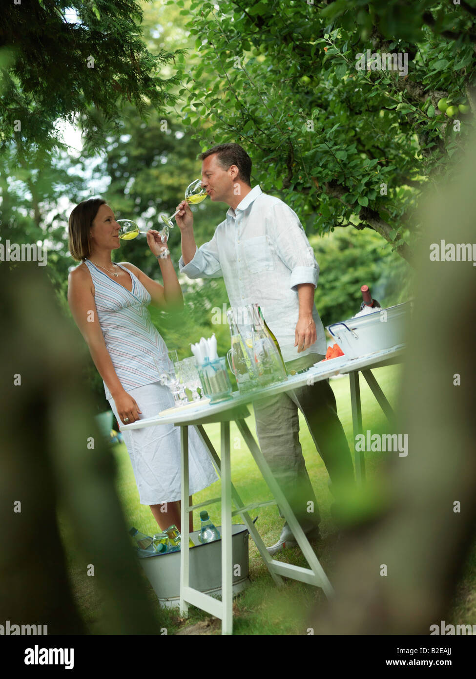 Couple drinking wine in garden Stock Photo Alamy