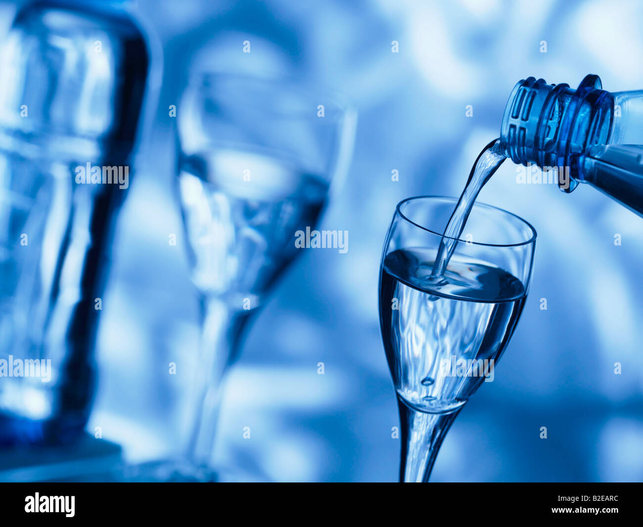 Close-up of water being poured into stem glass Stock Photo