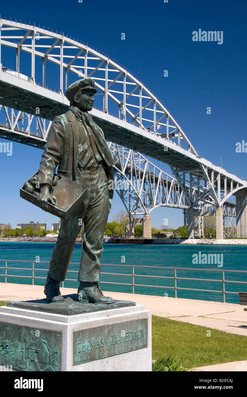 Thomas Edison by local artist Mino Duffy sits below the Blue Water Bridge along the St Clair River at Port Huron Michigan Stock Photo