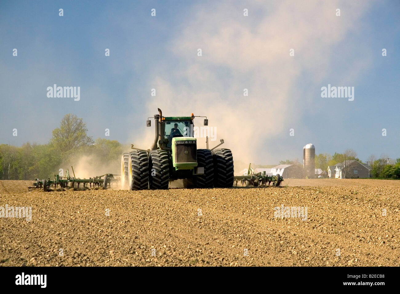 Tractor cultivating spring soil in Lapeer County Michigan Stock Photo