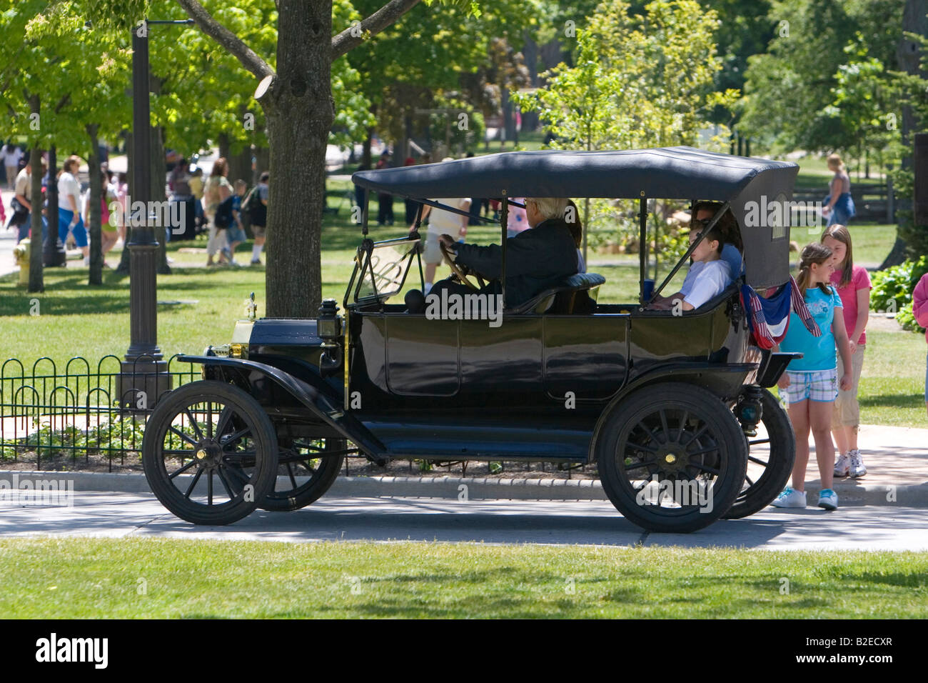 Visitors ride in a Ford Model T in Greenfield Village at The Henry Ford in Dearborn Michigan Stock Photo