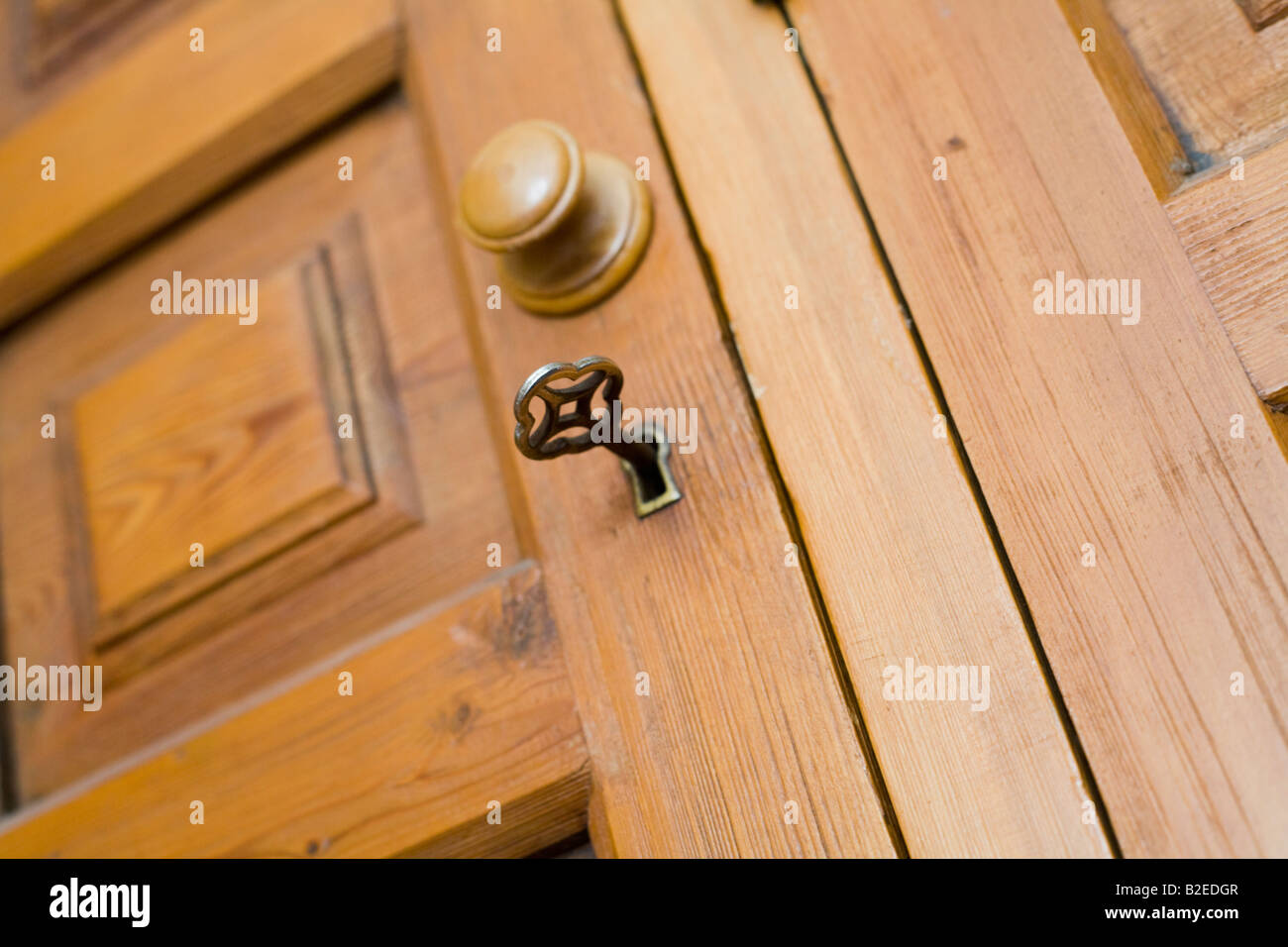 Key in lock in cupboard door Stock Photo Alamy