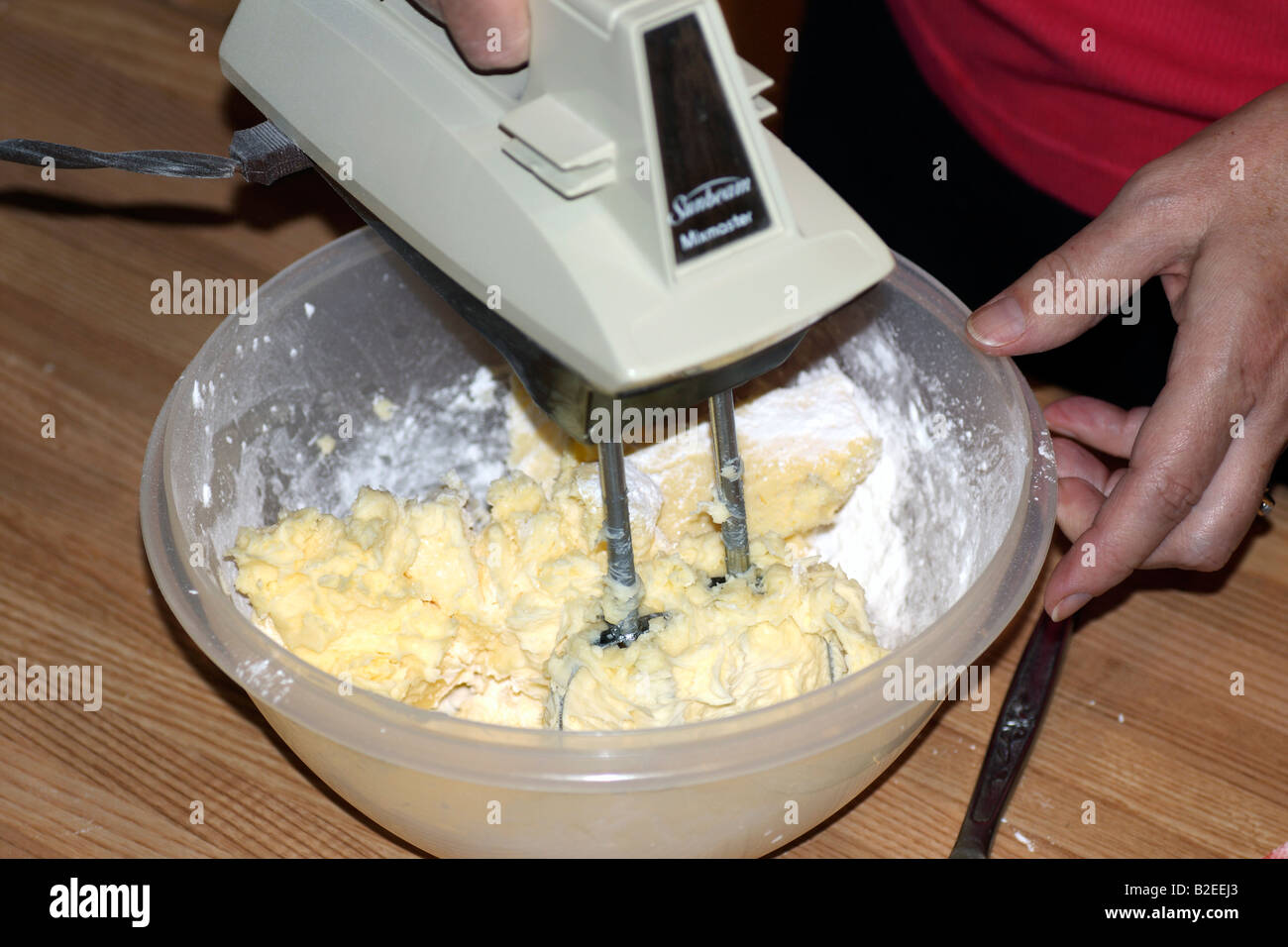 Electric whisk in mixing bowl with butter and flour