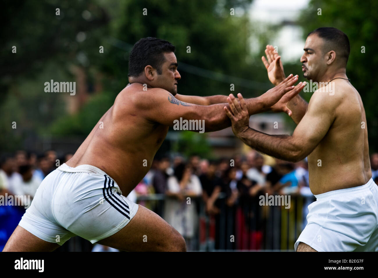 Two Kabbadi players struggle together at a match between Birmingham and Manchester. Stock Photo